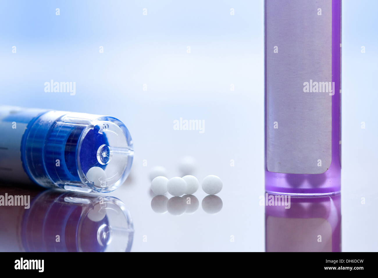 Macro view of homeopathic medications - containers and small white balls Stock Photo