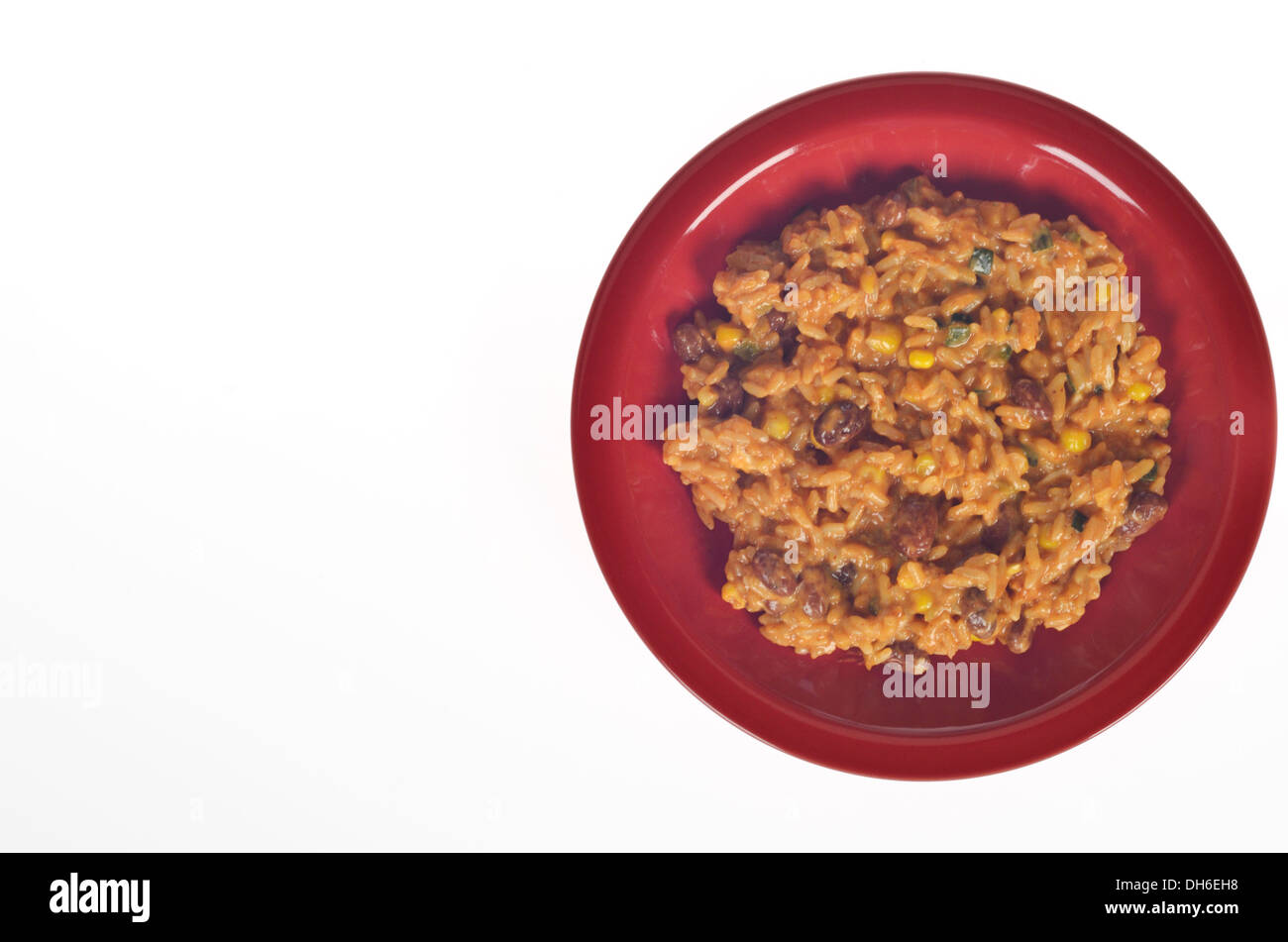 Plate of cooked red beans and rice with cheese on white background cutout. Stock Photo