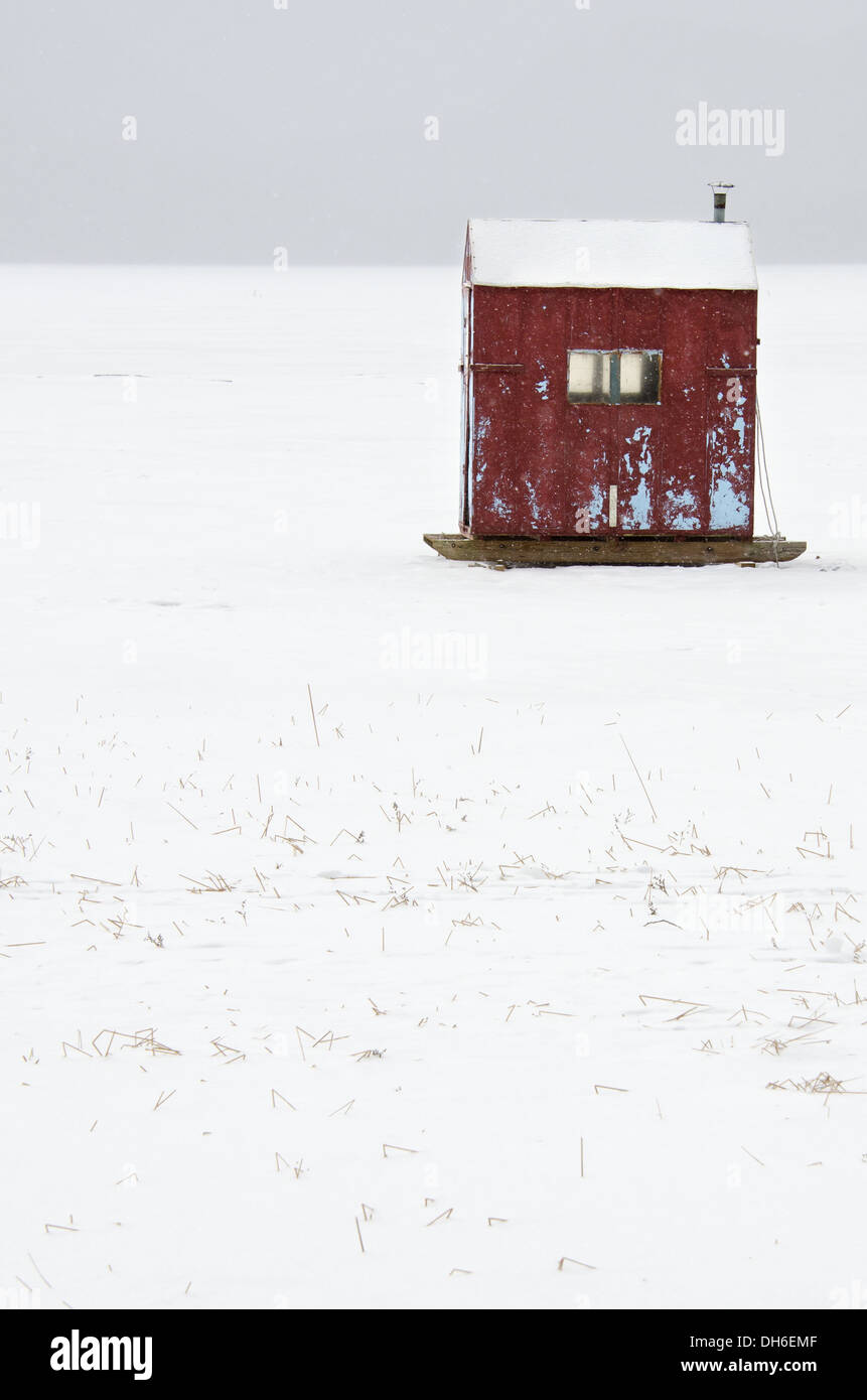 A red icefishing hut in a snow storm on Eagle Lake, Acadia National