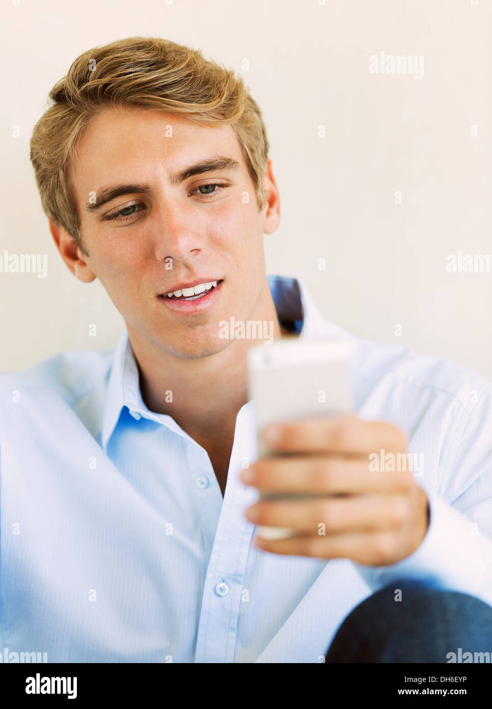 Young Professional, Handsome Man Using Smart Mobile Phone, Texting, Sending Text Message Stock Photo