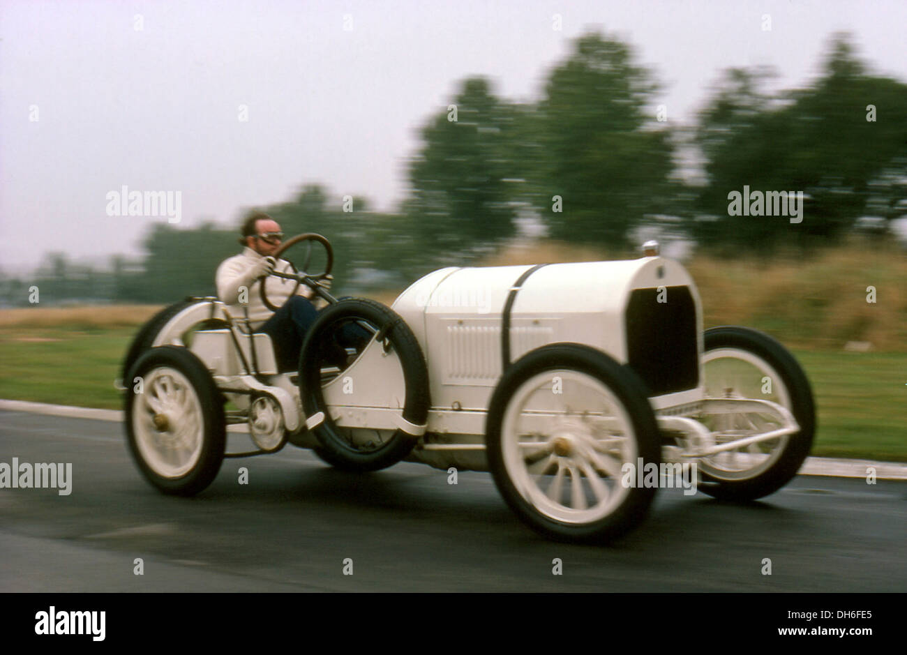 Doug Nye driving National Motor Museum's 1908 GP Mercedes Benz 12.5-litre 4-cylinder chain-drive car at Goodwood, England 1970s. Stock Photo