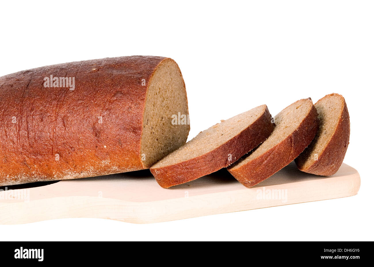 Dark bread with some sliced pieces of it placed on isolated background Stock Photo