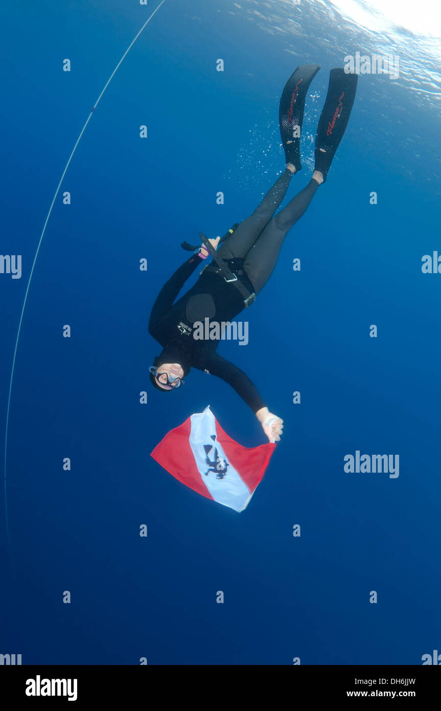 freedivers holds a diver down flag, Aegean Sea, island Symi, Greece Stock Photo