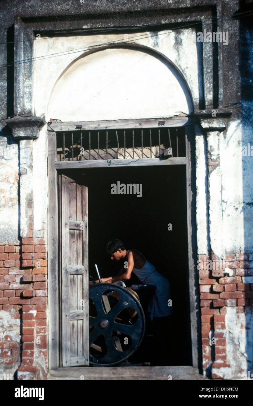 local man printing using an old platen type hand press in varanasi
