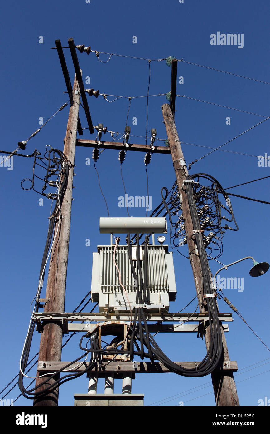 Complex electrical wiring and a sub-station supported on two poles on the Greek Island of Skiathos in the Aegean Sea. Stock Photo