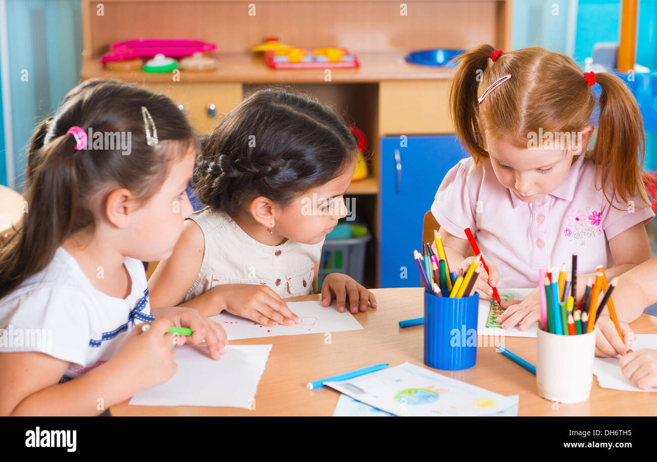 Group of cute little prescool kids drawing with colorful pencils Stock ...