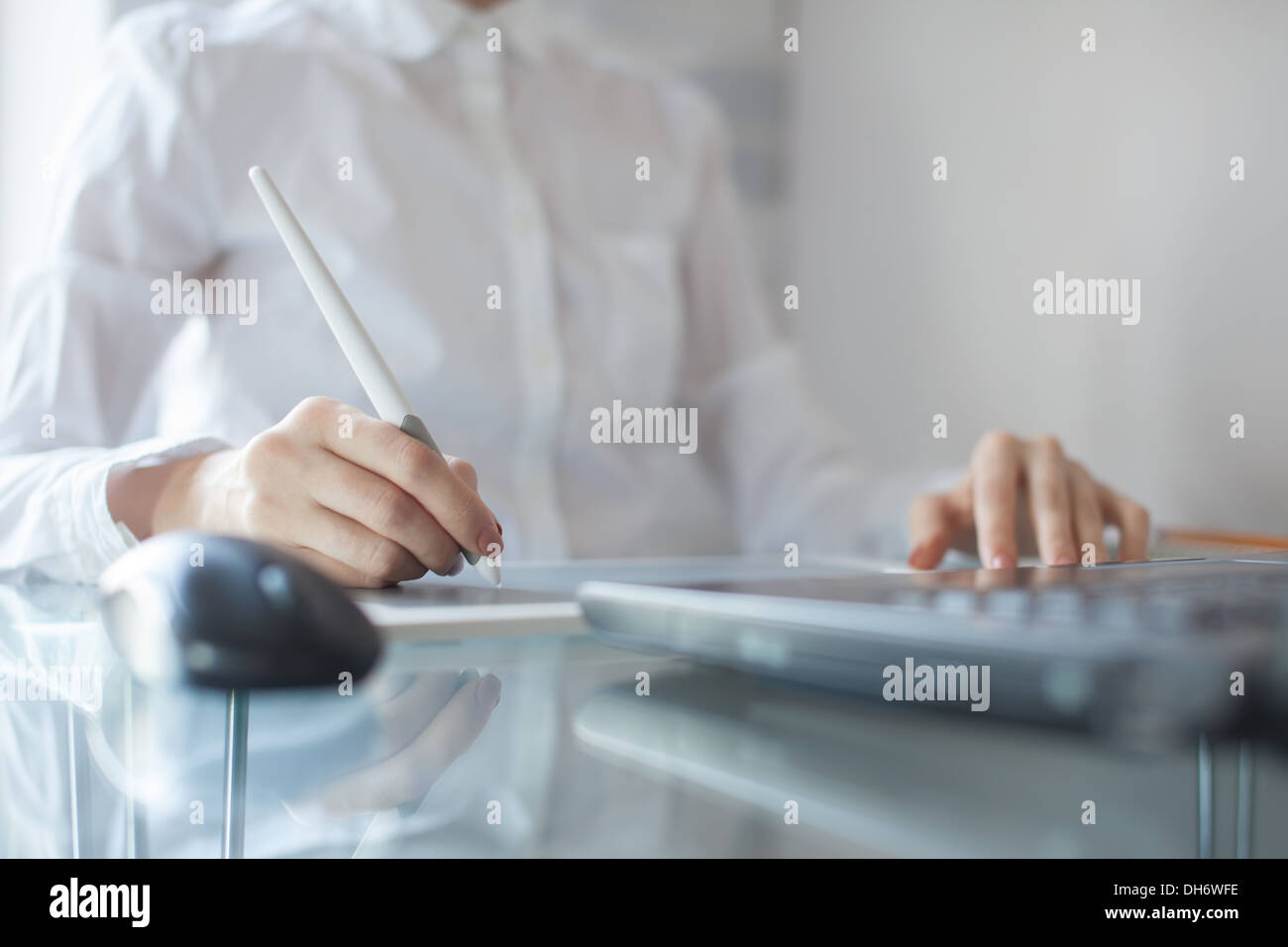Female designer using graphics pad in office Stock Photo