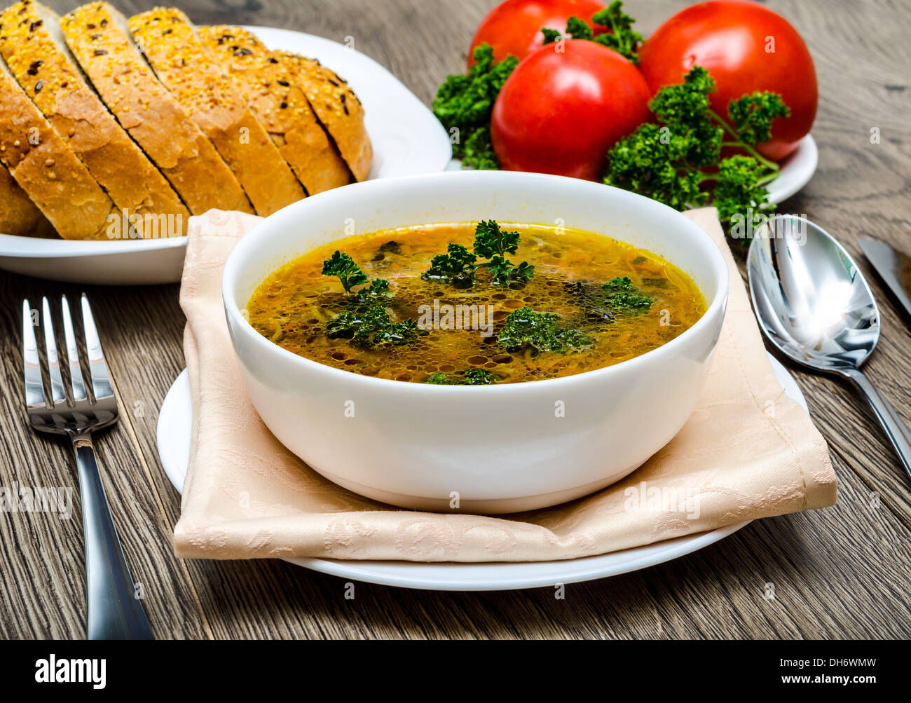 Soup. Photo Close-up plate of soup, bread and tomato. Stock Photo