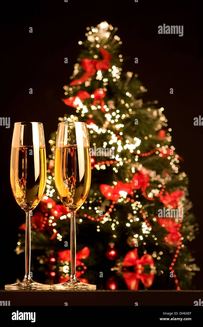 Romantic champagne flutes in front of a christmas tree Stock Photo Alamy