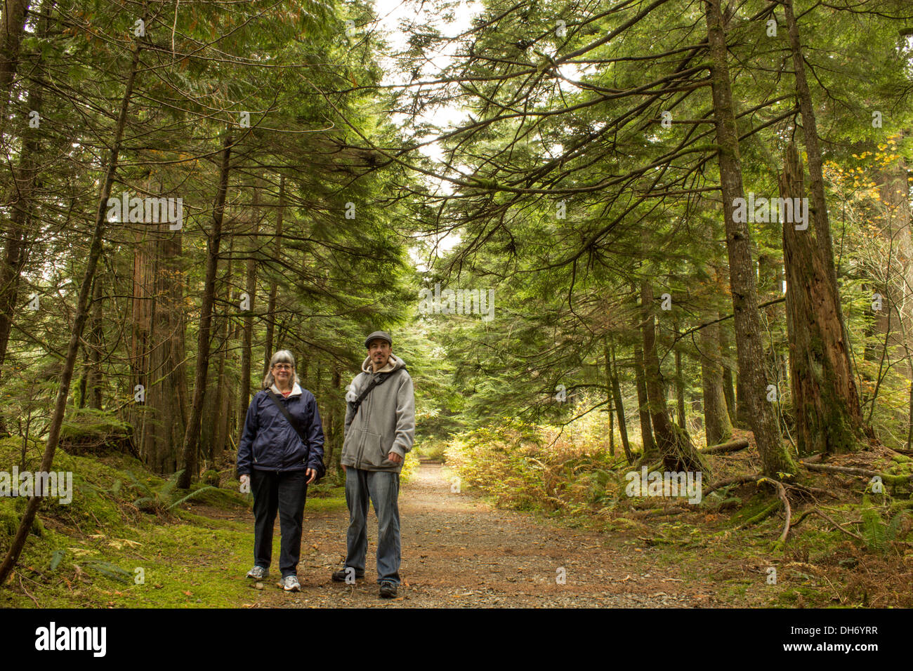 Mother and adult son hiking in woods on a fall day Stock Photo