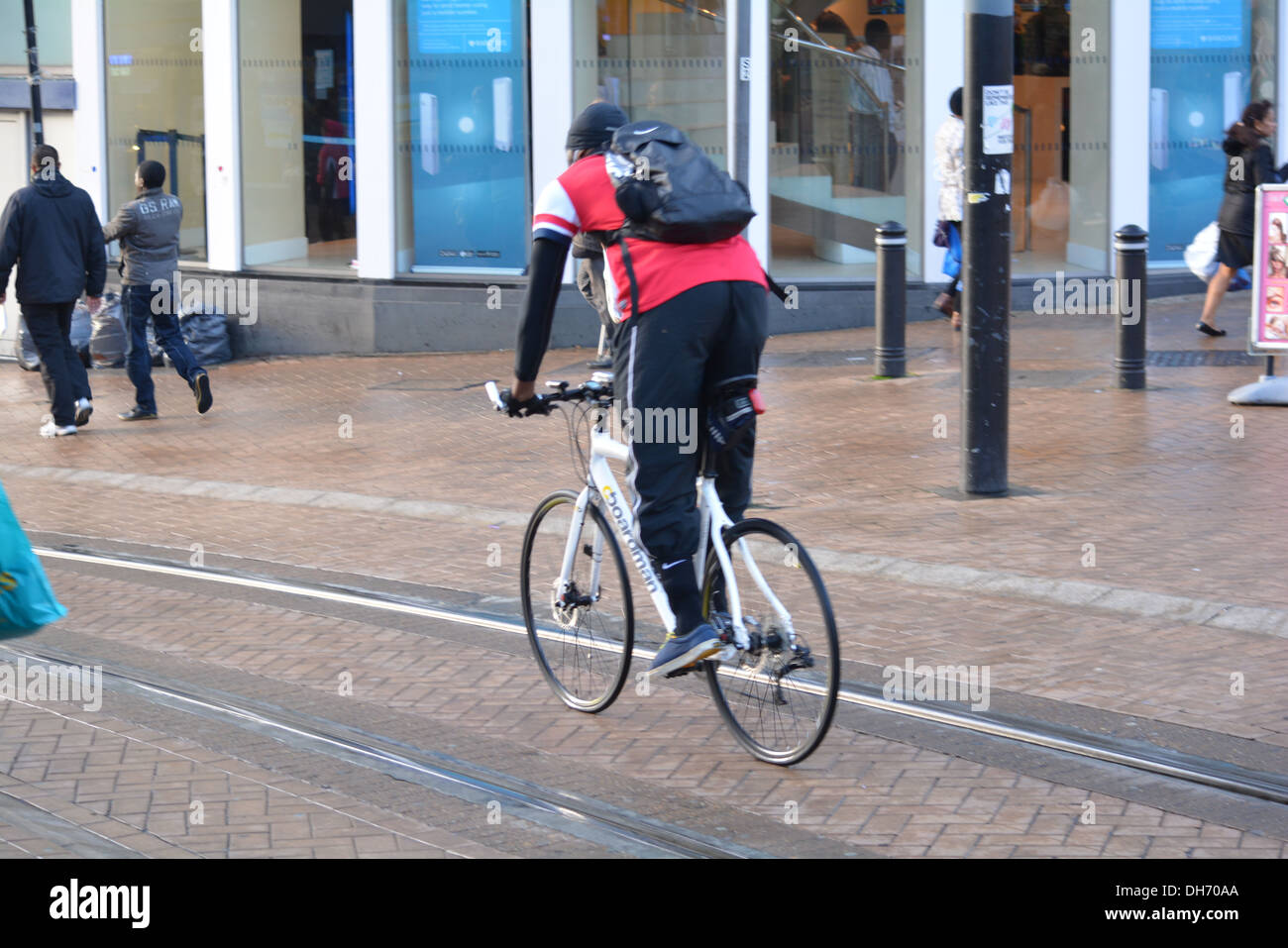 Man cycling down street in Croydon, on tram lines Stock Photo Alamy