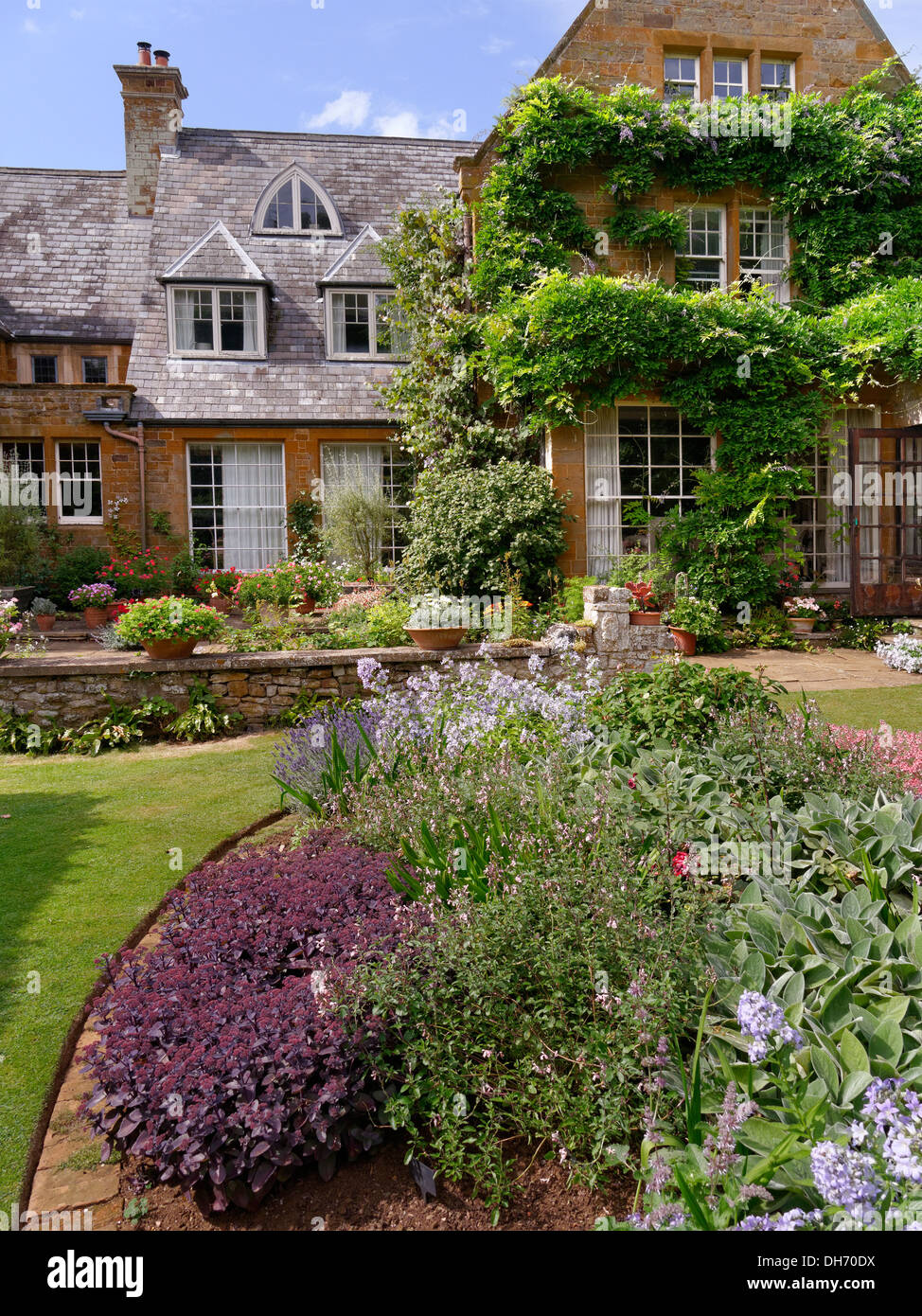 Flower beds in gardens of Coton Manor House, Coton, Northamptonshire, UK. Stock Photo
