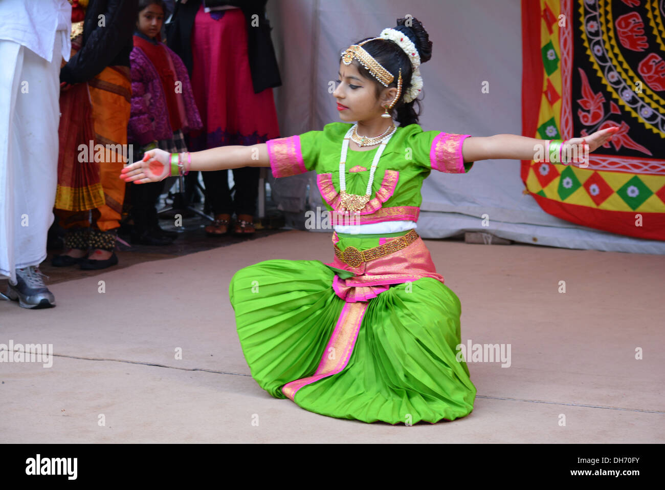 Young Hindu girl doing traditional dancing in the High street in