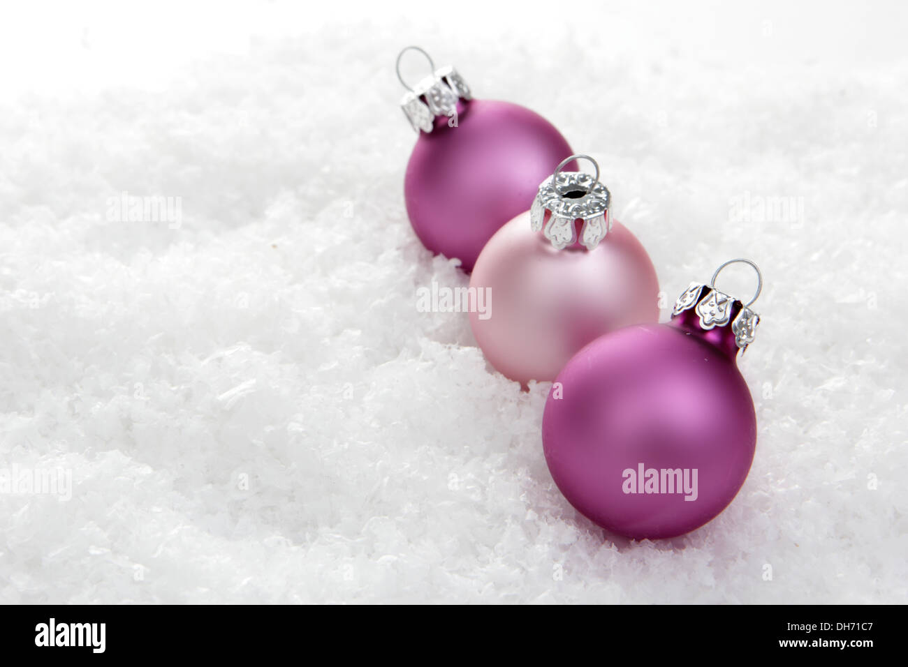 christmas, pink christmas balls on artificial snow with white background Stock Photo