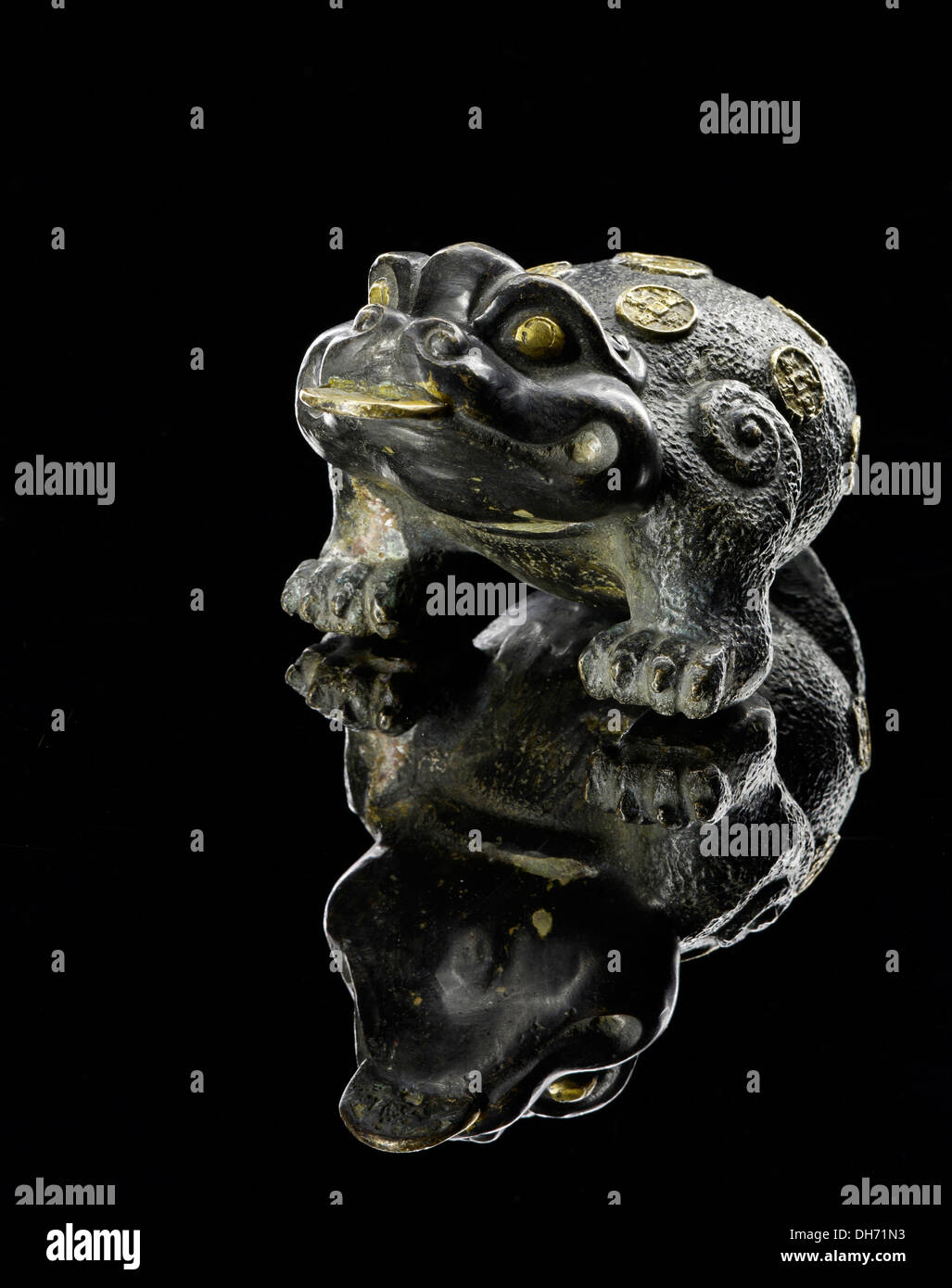 Lucky copper toad chromed with gold coins Stock Photo