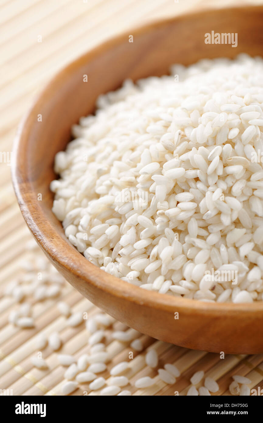 Wooden bowl full of carnaroli type rice. This rice is used for risotto