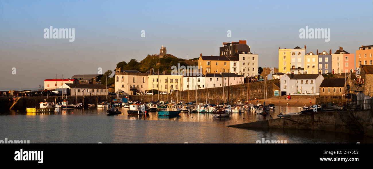 Letter-box format view of Tenby Harbour in golden evening light. Stock Photo