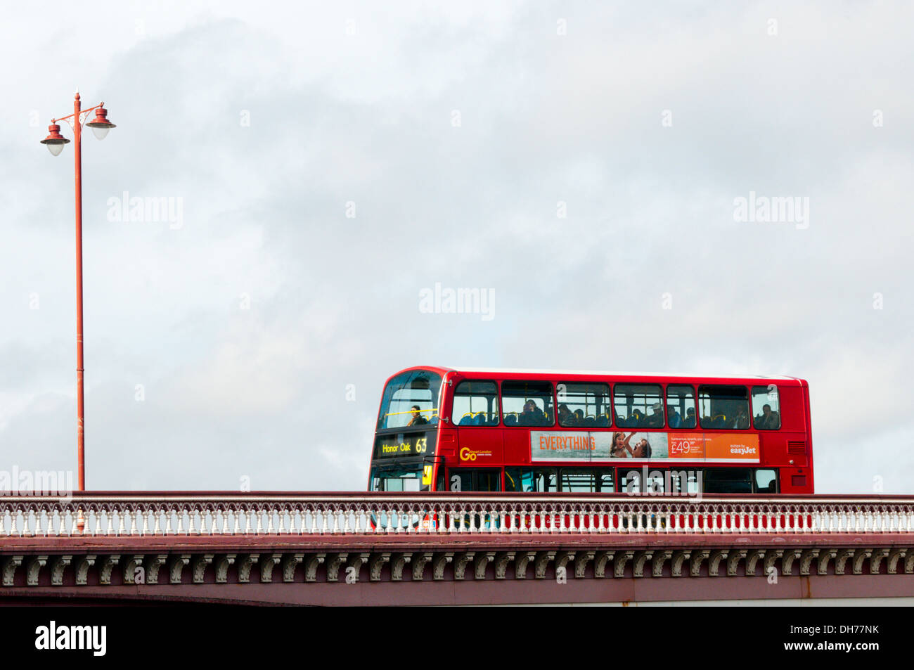 A hybrid red London double-decker bus crossing Blackfriars Bridge. Stock Photo