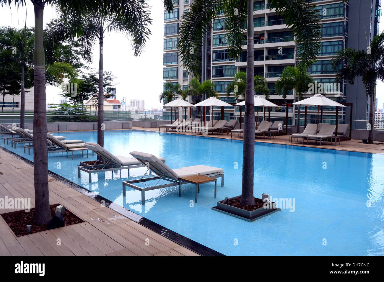Lounge Chairs By Swimming Pool In Condominium High Rise