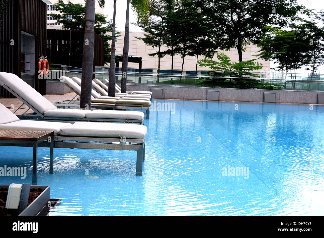 Lounge Chairs By Swimming Pool In Condominium High Rise