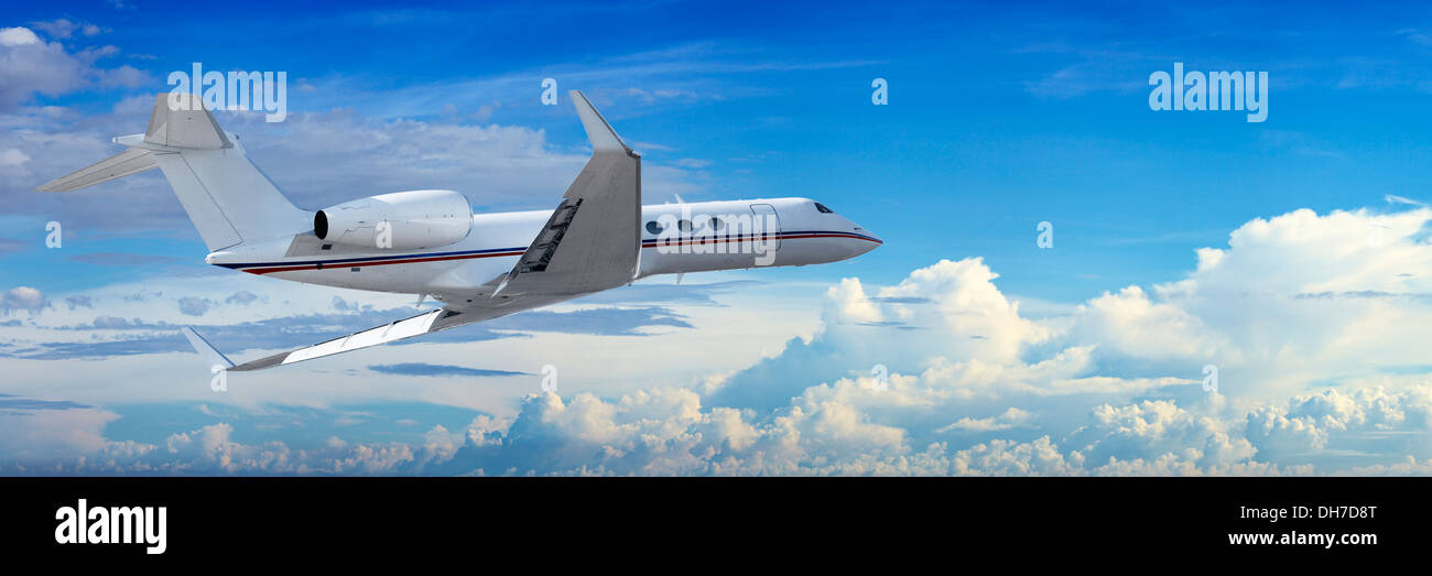 Corporate jet cruising in a cloudy sky Stock Photo