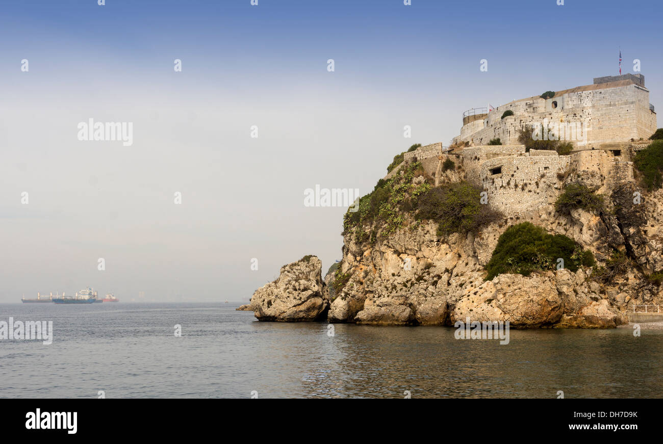 FORTRESS GIBRALTAR ON THE TOP OF THE LIMESTONE ROCKS OVERLOOKING THE SEA AND SHIPS IN THE ROADS Stock Photo