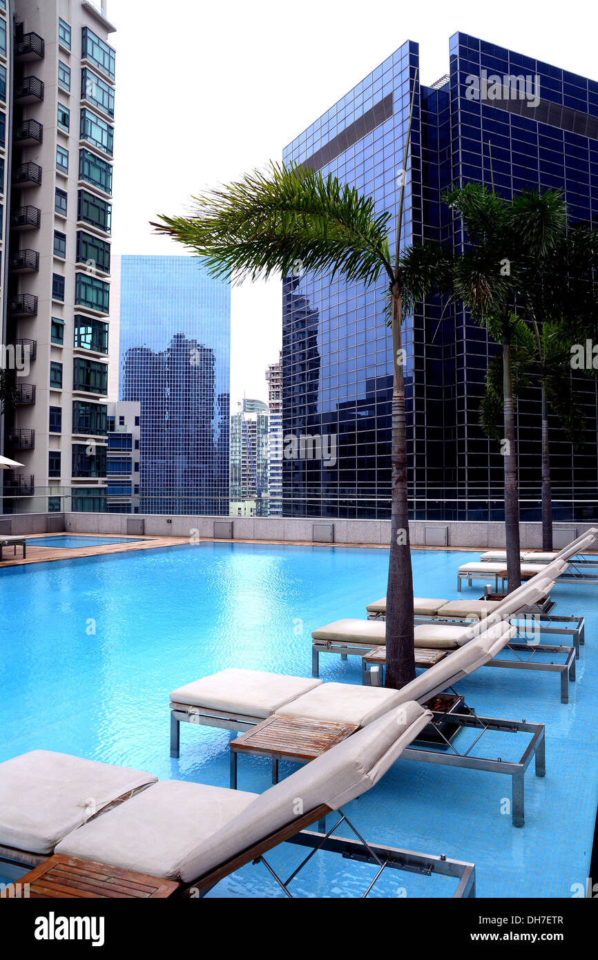 Lounge Chairs By Swimming Pool In Condominium High Rise
