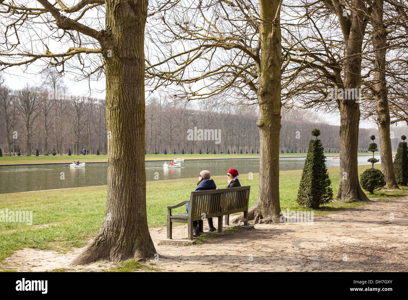 two women sitting on a park bench in the gardens of Versailles, Paris,  France Stock Photo - Alamy