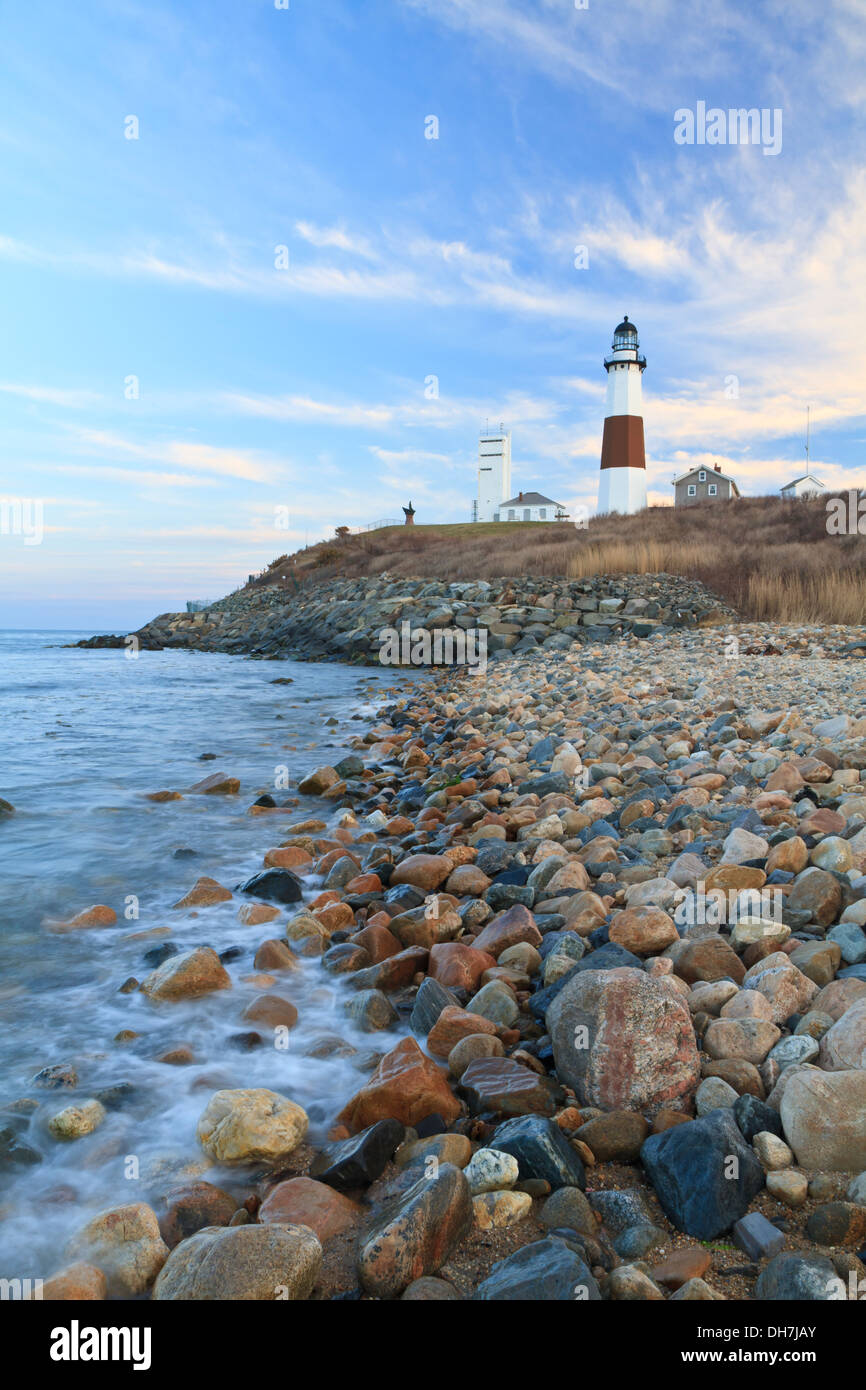 Waves from the Atlantic Ocean froth on the rocks below Montauk Lighthouse at the Eastern end of Long Island, New York Stock Photo