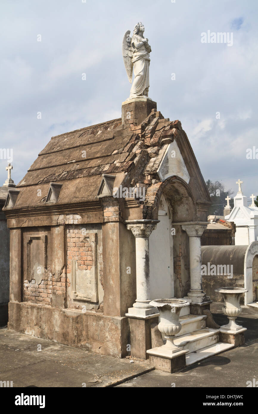 An angel statue sits atop a tomb in Lafayette Cemetery #2 in the Garden District in New Orleans, Louisiana Stock Photo