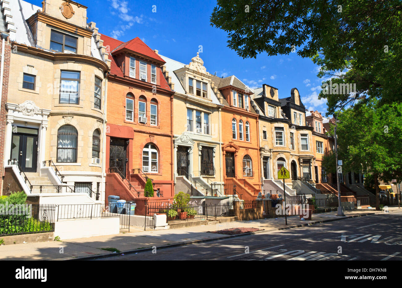 A row of unique townhouse apartment buildings with stoops on New York Ave. in the Crown Heights neighborhood of Brooklyn, NY Stock Photo