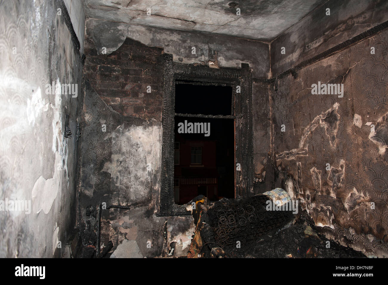 Burnt out house bedroom severe hot fire brick exposed Stock Photo