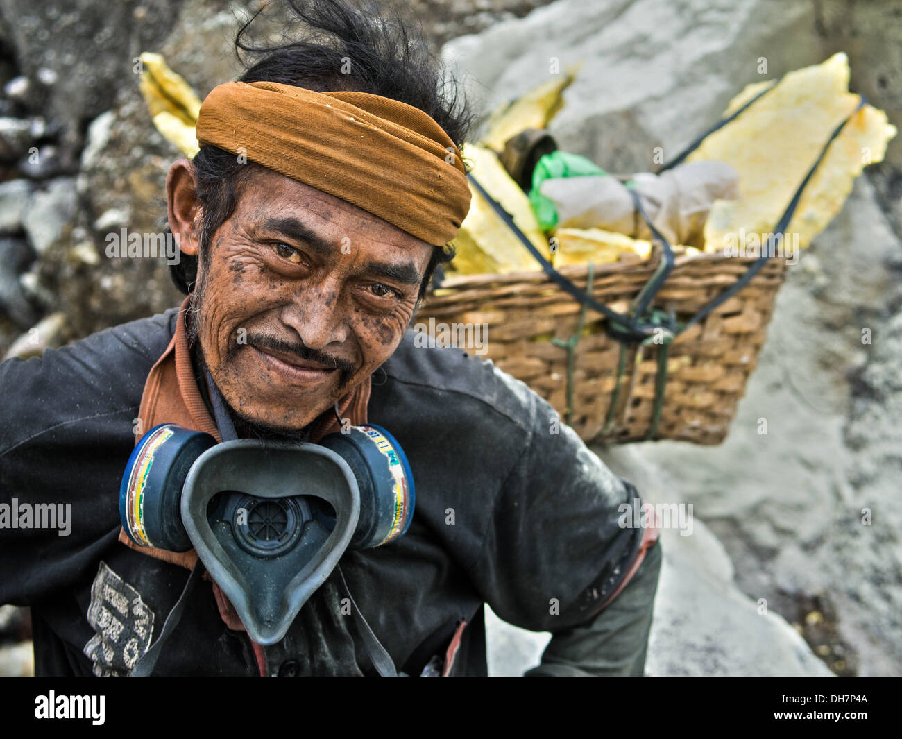 Sulfur miner at Kawah Ijen volcano crater in East Java, Indonesia. Stock Photo