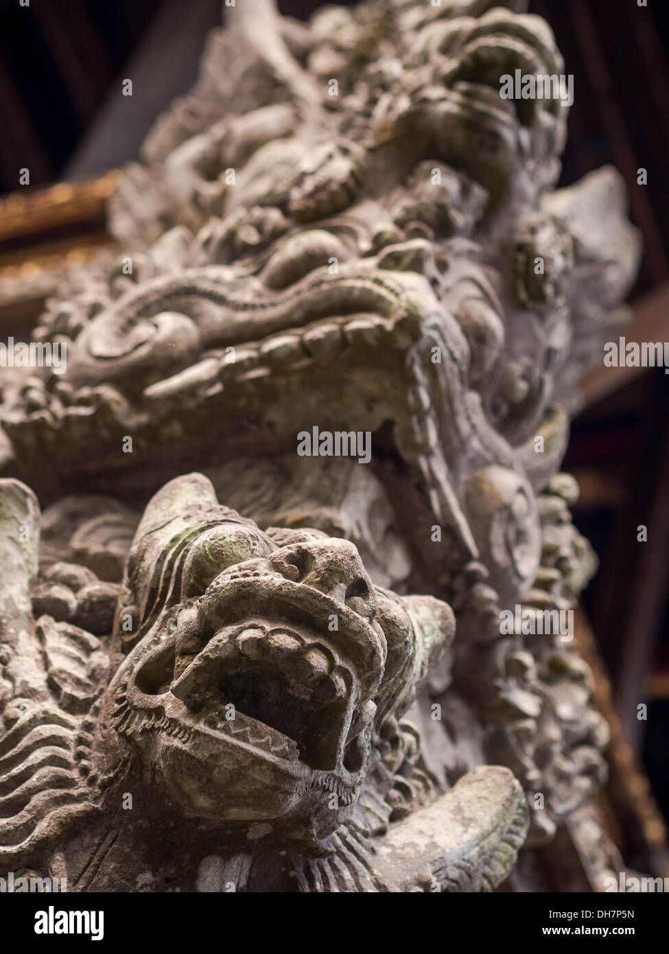 Carvings depicting demons and deities from Balinese mythology adorn the Pura Dalem Agung Padangtegal temple in Ubud, Bali. Stock Photo