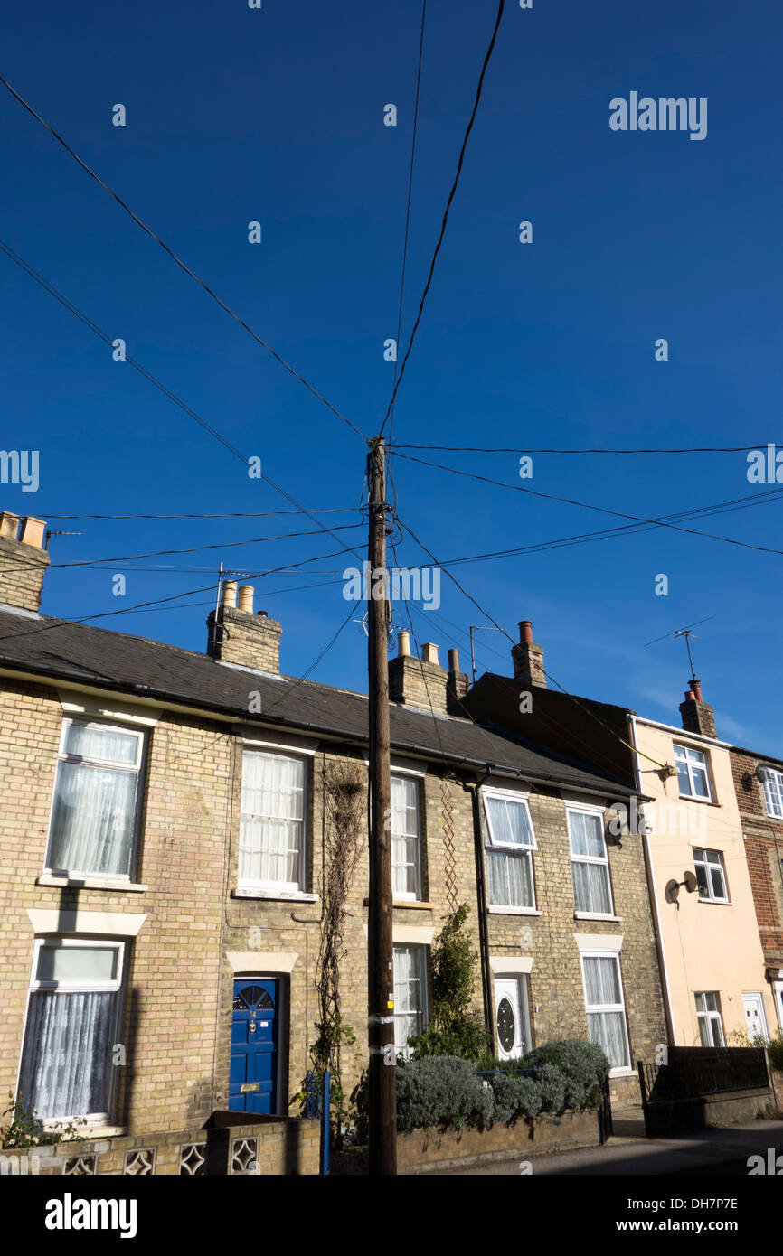 Overhead electric power cables running from a central wooden pole to a