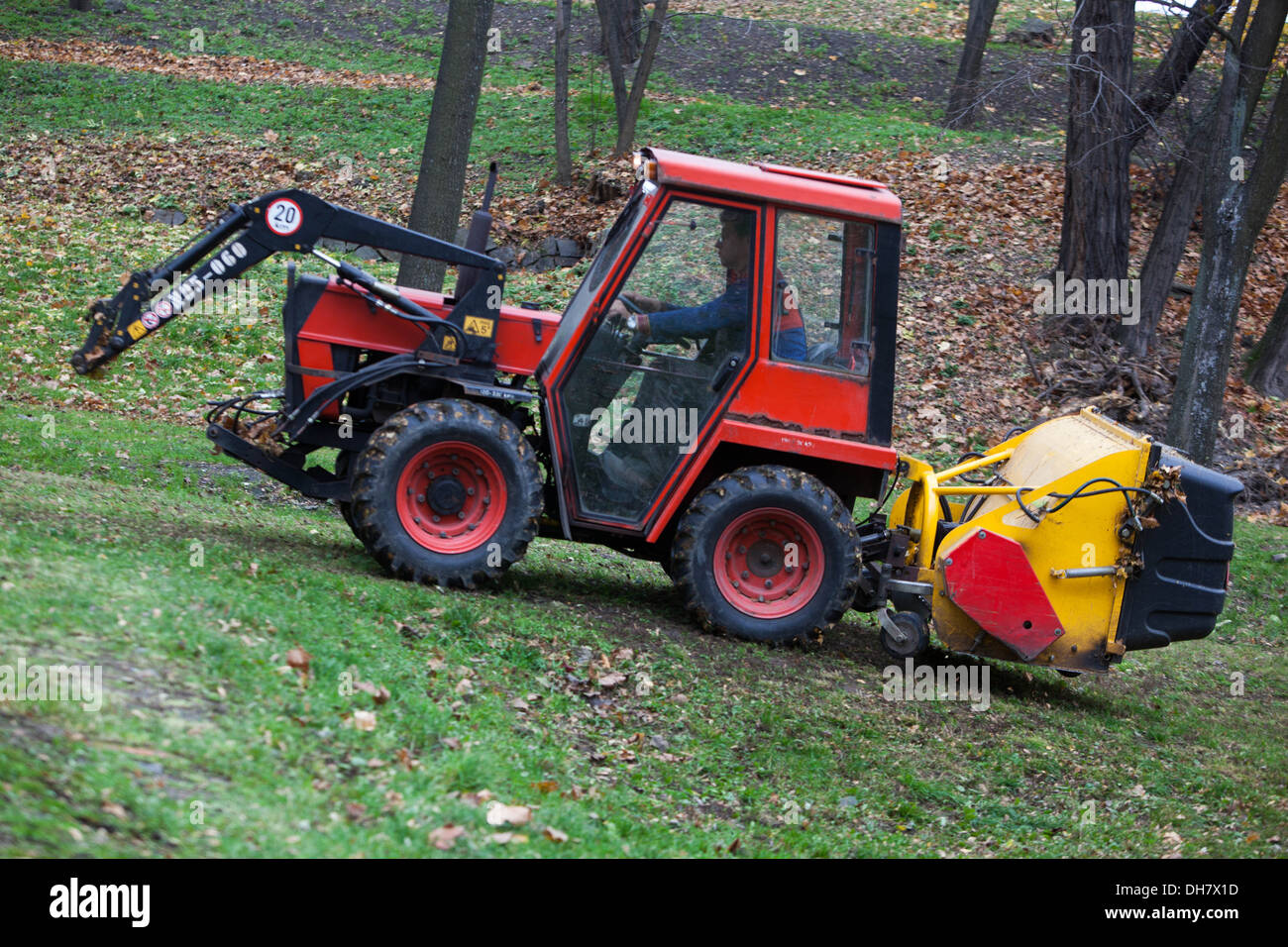 Small tractor cleaning of fallen leaves in the City park, Prague Czech Republic Stock Photo