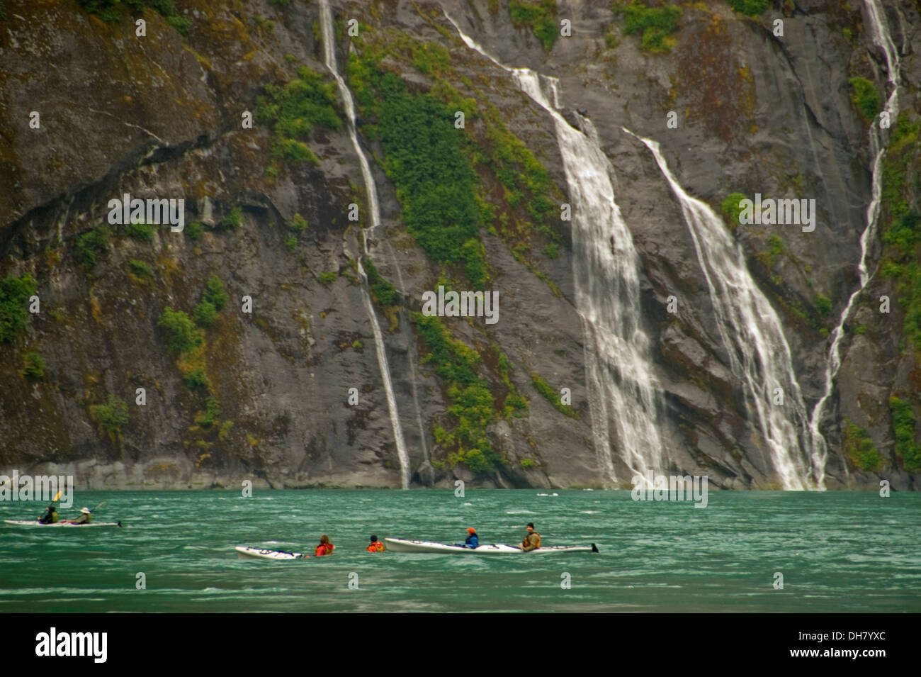 Kayakers paddle by 'no-name' waterfalls in Ford's Terror off Endicott Arm, Alaska Stock Photo