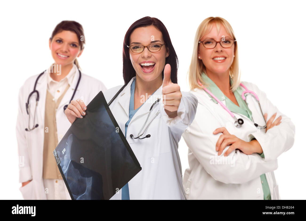 Three Mixed Race Female Doctors or Nurses with Thumbs Up Holding X-ray Isolated on White. Stock Photo