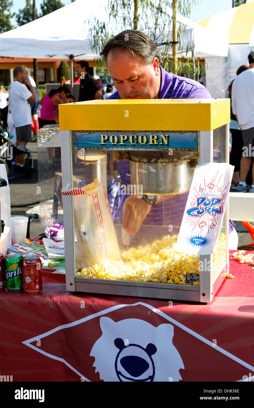 A man with a  popcorn machine at the Tustin Dino dash event in Southern California USA Stock Photo