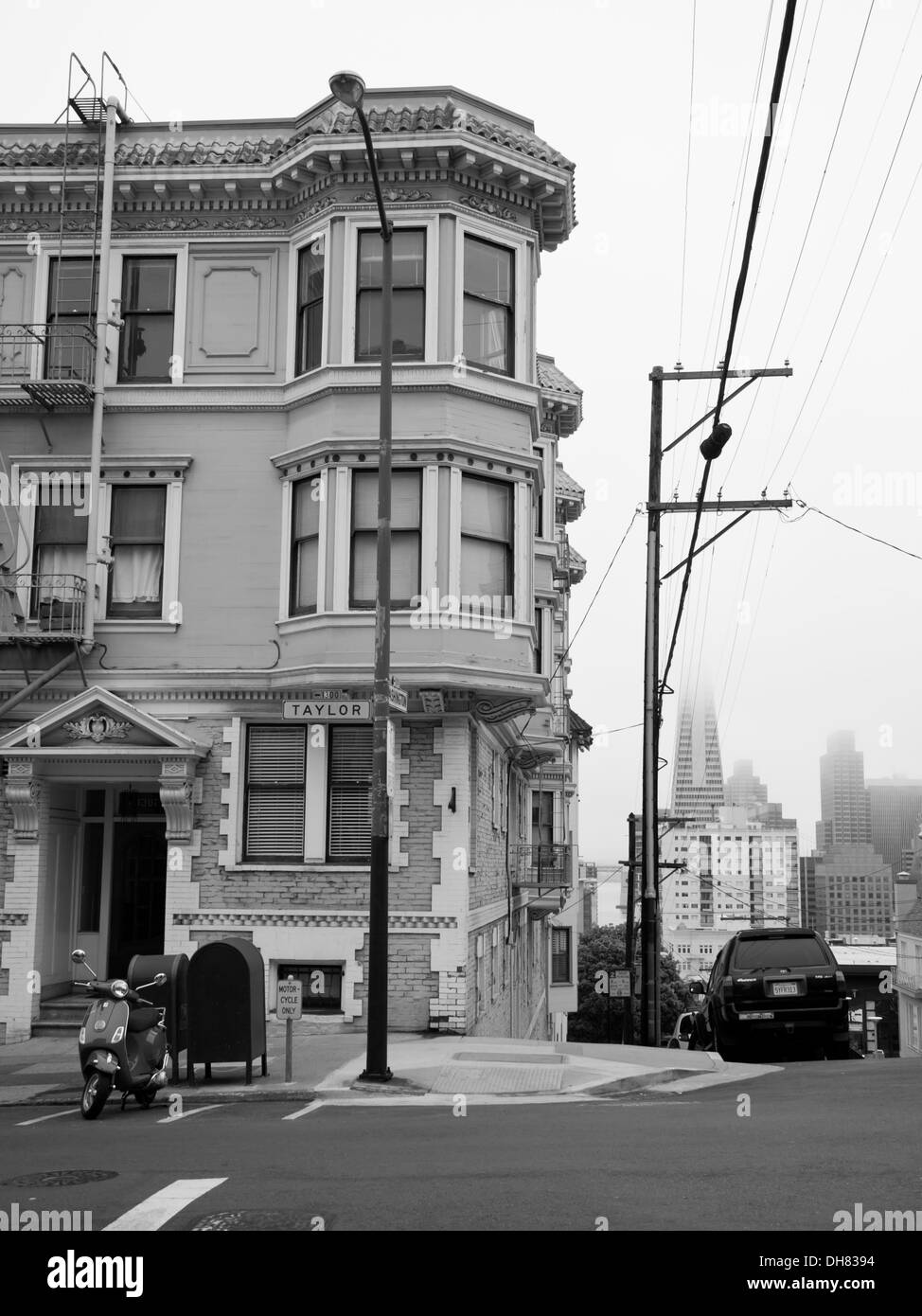 A black-and-white picture of a characteristic San Francisco rowhouse at the intersection of Taylor and Washington Streets. Stock Photo