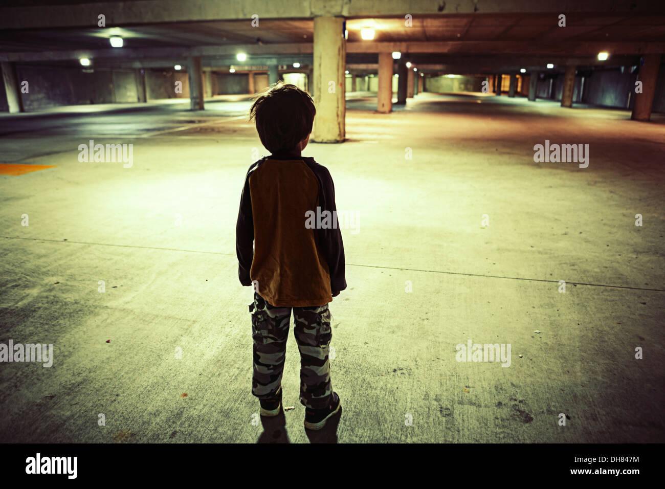 Boy in underground car park Stock Photo