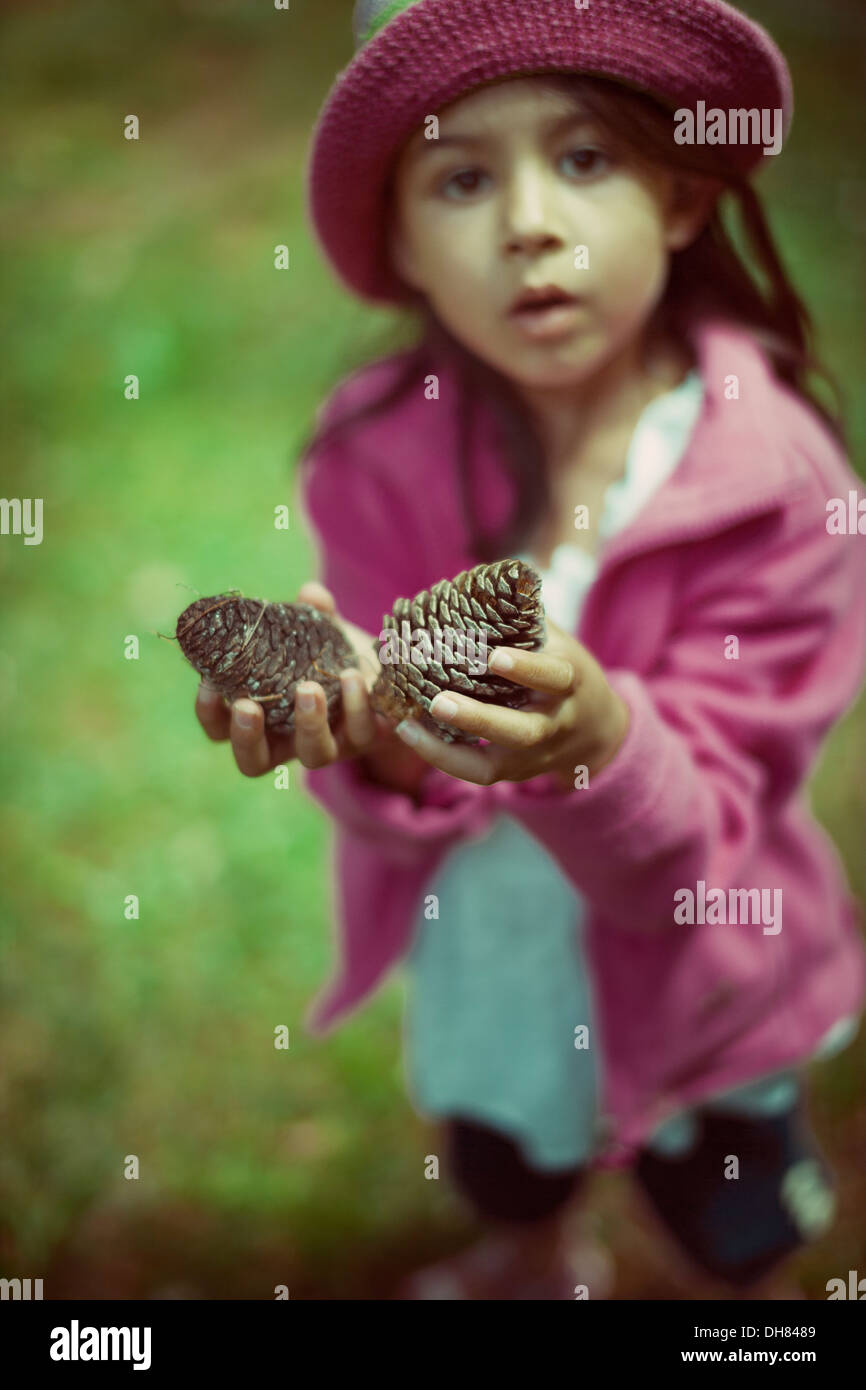 Girl holding pine cones Stock Photo