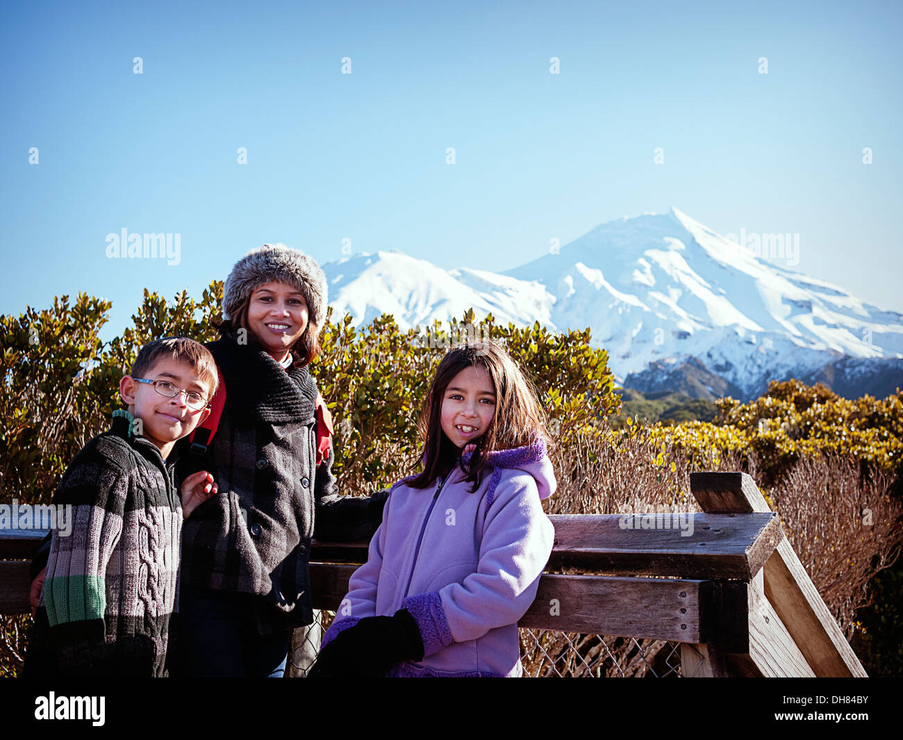 Mother, son, daughter, Taranaki volcano, Mount Egmont, New Zealand, sunny winter day. Stock Photo