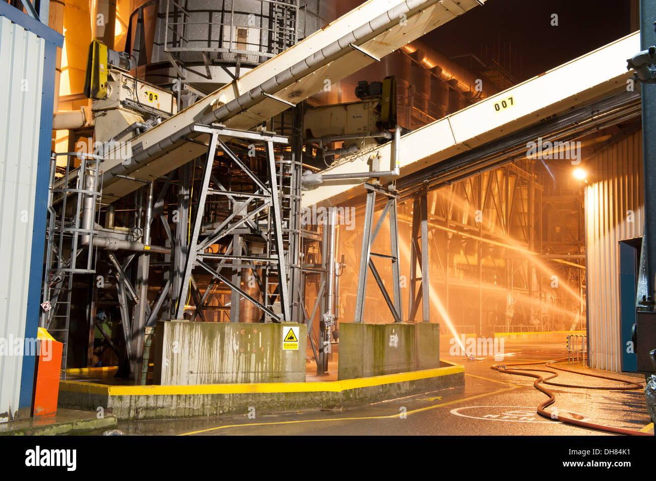 Factory on Fire at Night Plant Processing Ground Monitors Stock Photo