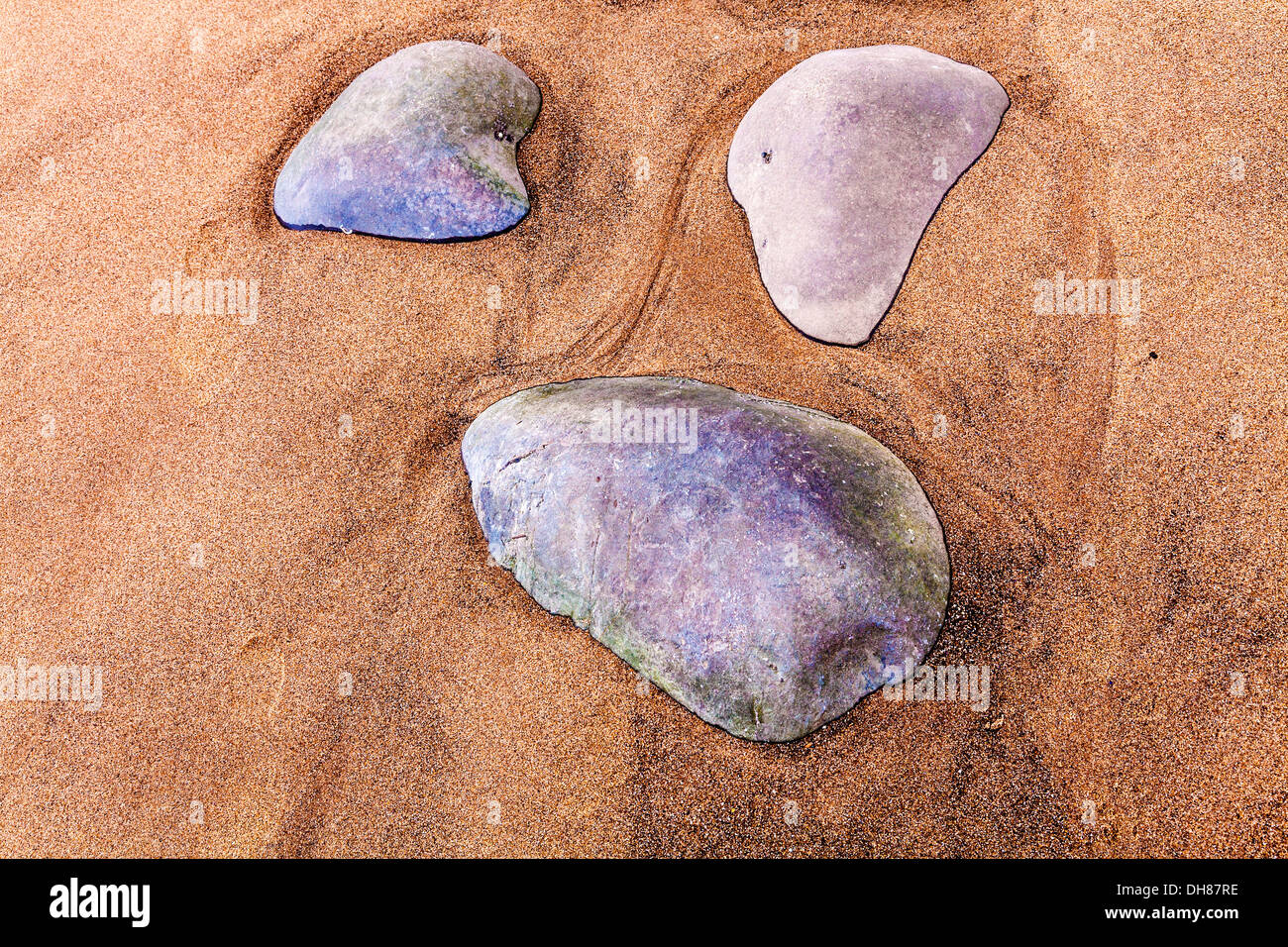 An abstract image of rocks and sand forming patterns on the beach at Nash Point in Wales. Stock Photo