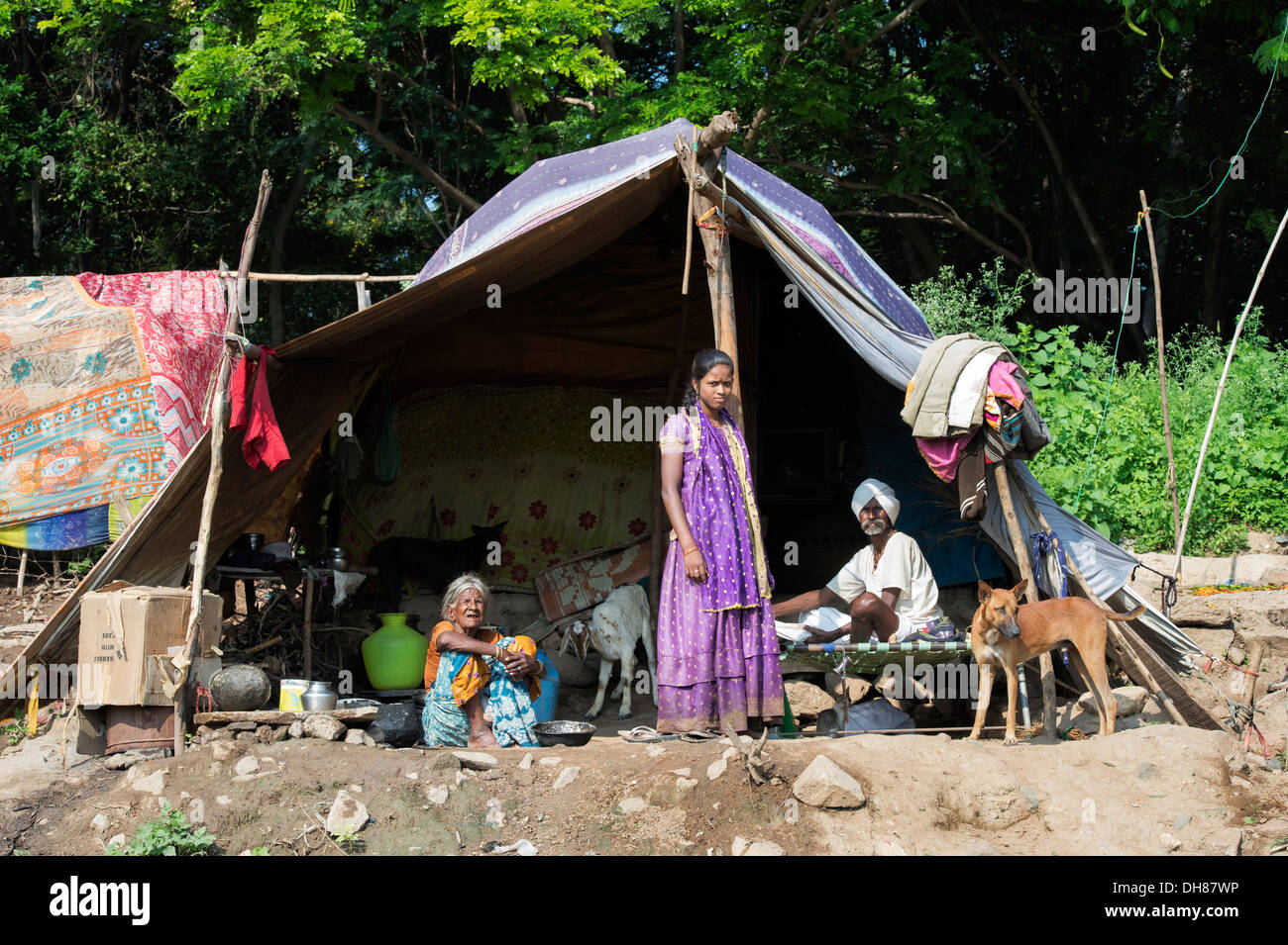 Lower caste Indian family sitting and standing by their bender / tent / shelter. Andhra Pradesh, India. Stock Photo