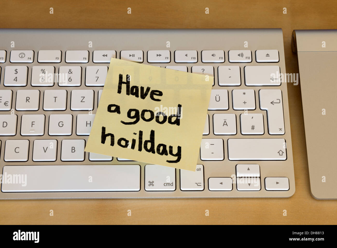 'Have a good holiday' sticky note on computer keyboard Stock Photo