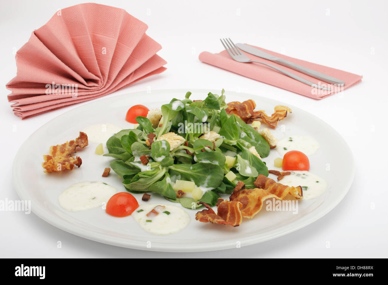 Field salad with potato dressing, bread croutons and fried bacon Stock Photo