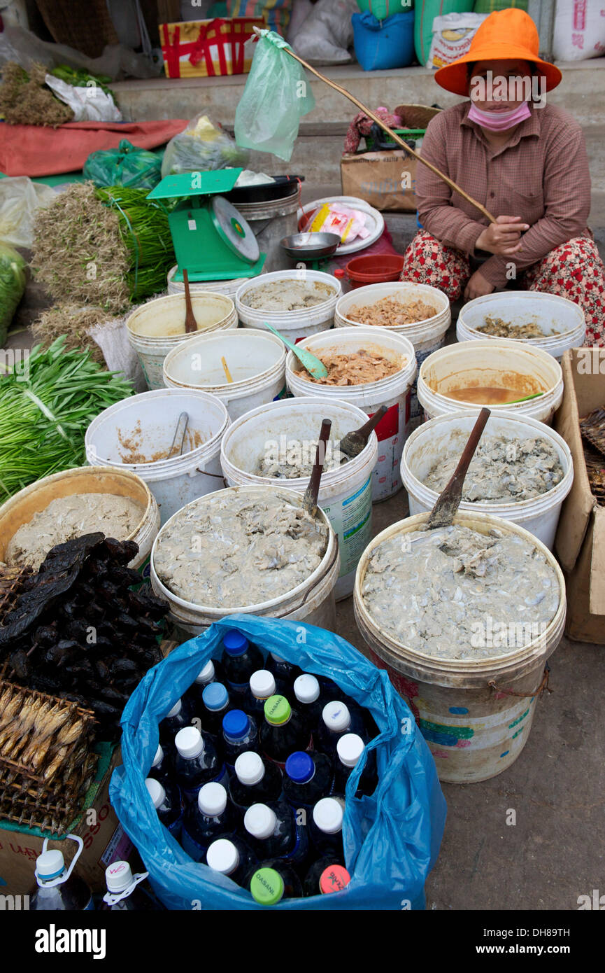 Woman selling fermented fish paste at a market, Siem Reap, Siem Reap, Siem Reap Province, Cambodia Stock Photo