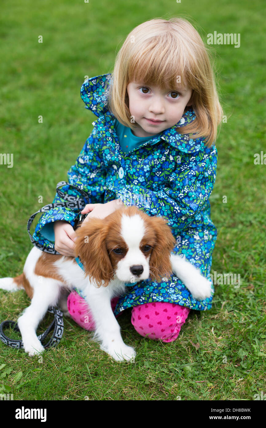 Pretty Little Girl With Pet Puppy Stock Photo